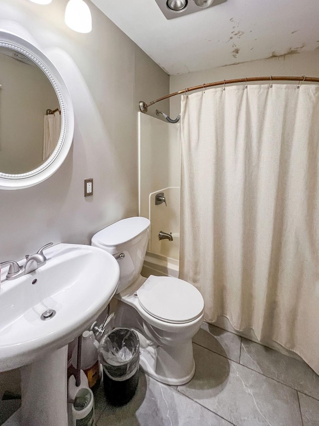 full bathroom with shower / bath combo, sink, and toilet