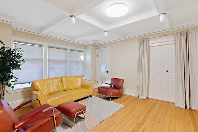 living room with a healthy amount of sunlight, wood-type flooring, coffered ceiling, and beamed ceiling