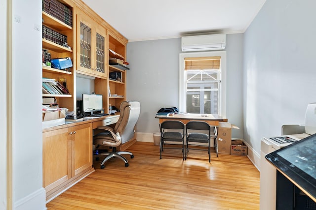 home office with ornamental molding, an AC wall unit, and light hardwood / wood-style flooring