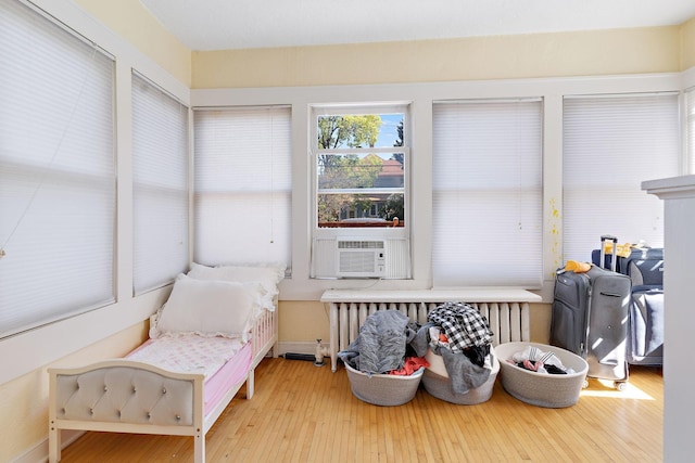 sitting room with wood-type flooring and cooling unit