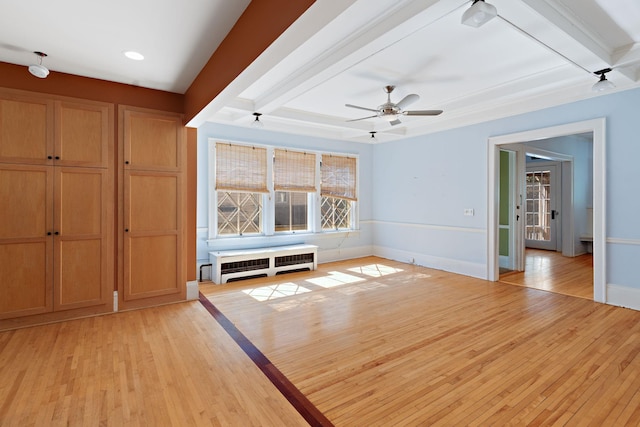 unfurnished living room with ceiling fan, radiator, and light hardwood / wood-style floors