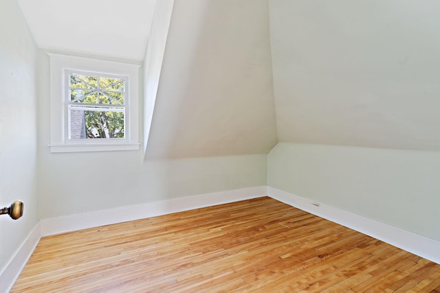 bonus room featuring lofted ceiling and light hardwood / wood-style floors