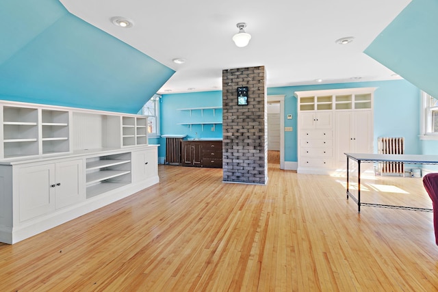 interior space with light hardwood / wood-style flooring, plenty of natural light, and radiator heating unit