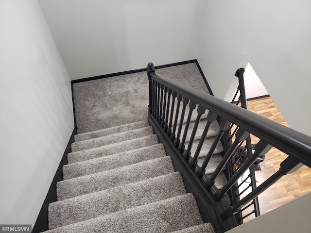 staircase featuring hardwood / wood-style floors