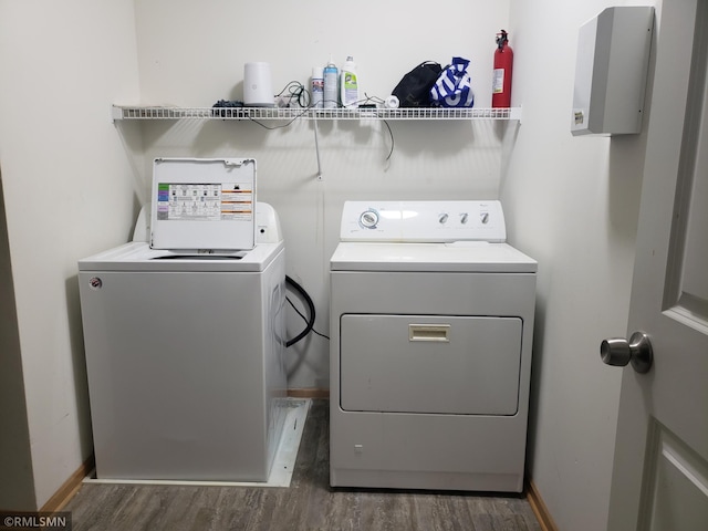 washroom with dark hardwood / wood-style floors and independent washer and dryer