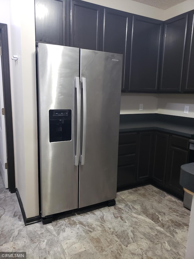 kitchen featuring stainless steel refrigerator with ice dispenser