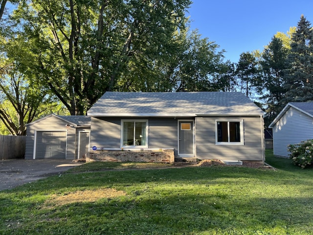 single story home with a garage and a front yard