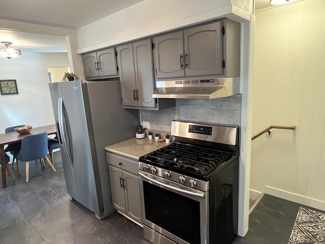 kitchen with appliances with stainless steel finishes, backsplash, and gray cabinetry