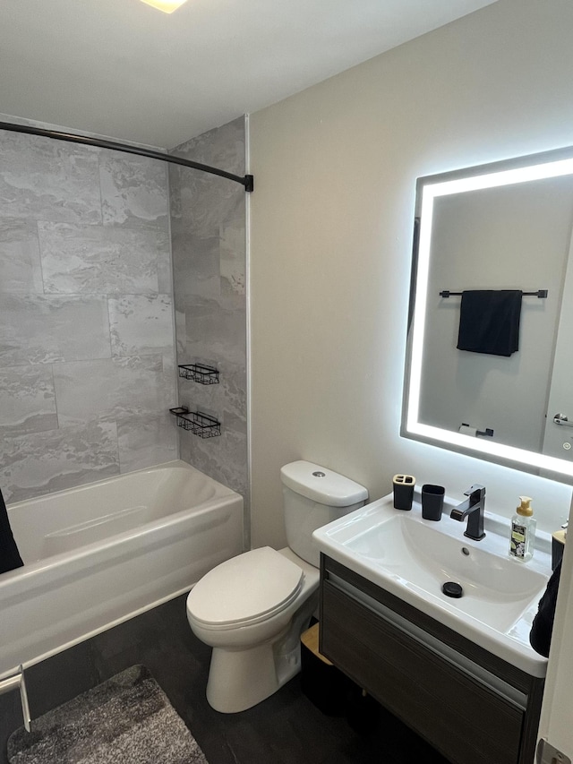 full bathroom featuring tiled shower / bath combo, vanity, and toilet