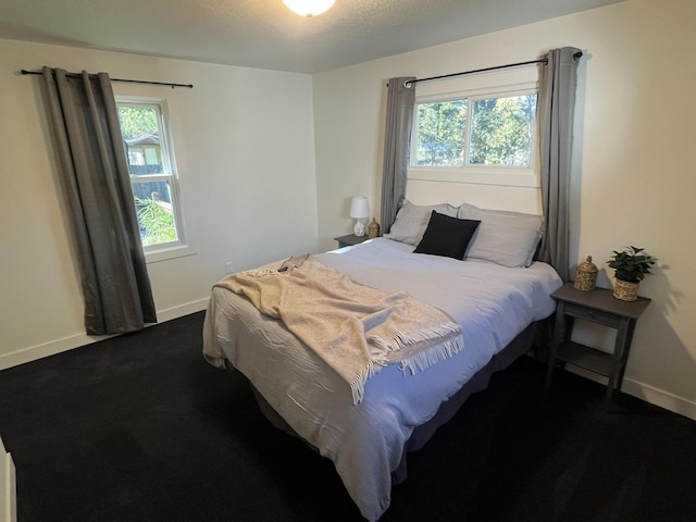 carpeted bedroom featuring multiple windows