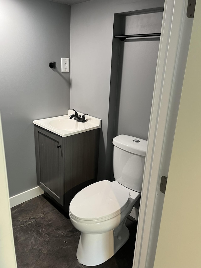 bathroom with toilet and vanity