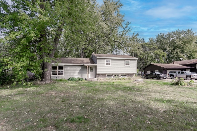 back of house with a carport and a lawn