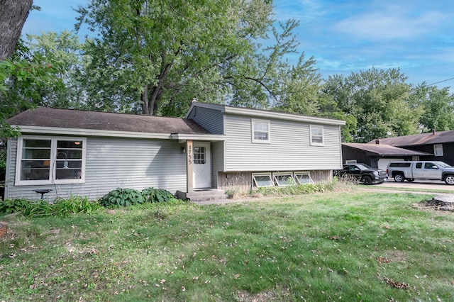 tri-level home with a front lawn