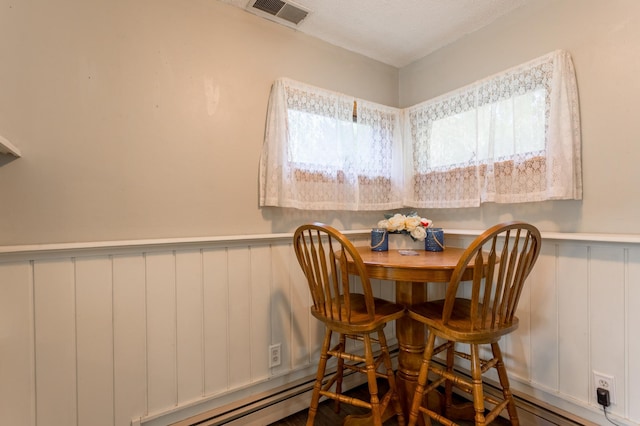 dining area featuring a textured ceiling