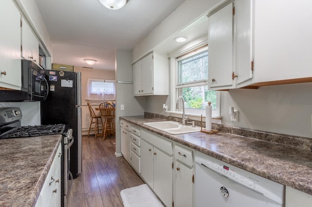 kitchen with dark hardwood / wood-style floors, white cabinets, gas stove, sink, and dishwasher