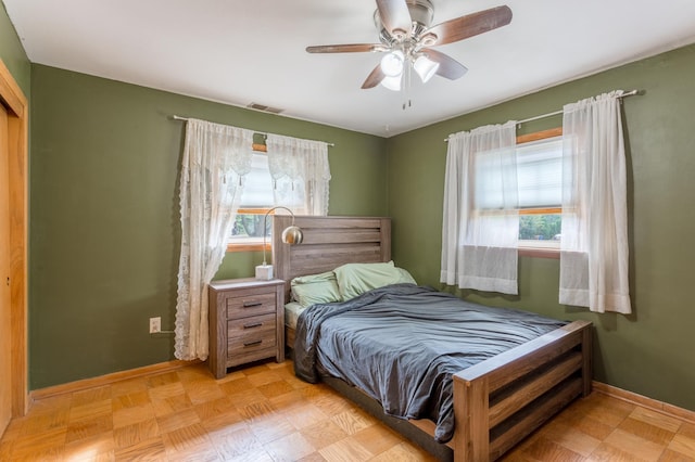 bedroom featuring ceiling fan and light parquet flooring