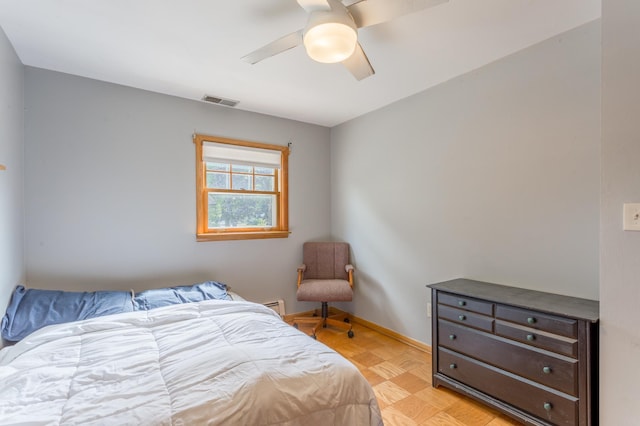 bedroom featuring ceiling fan and light parquet floors