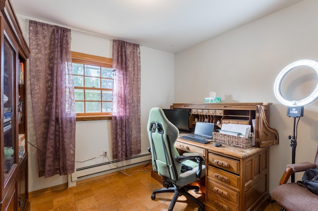 office space featuring a baseboard radiator and light parquet flooring