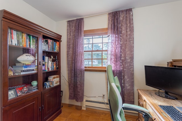 home office featuring light parquet flooring and a baseboard heating unit