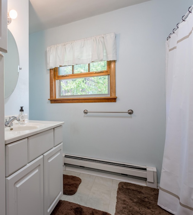 bathroom with tile patterned flooring, a baseboard heating unit, and vanity