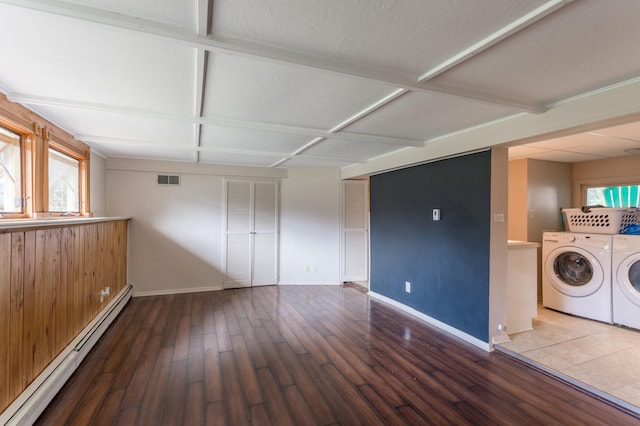 interior space with washer and clothes dryer, hardwood / wood-style flooring, a baseboard radiator, and a textured ceiling