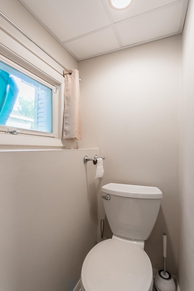 bathroom featuring a paneled ceiling and toilet