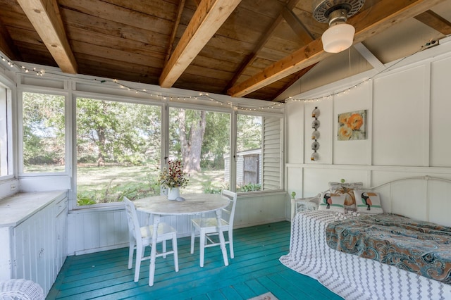 unfurnished sunroom with lofted ceiling with beams, a healthy amount of sunlight, and wooden ceiling