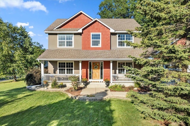 view of front facade with covered porch and a front yard