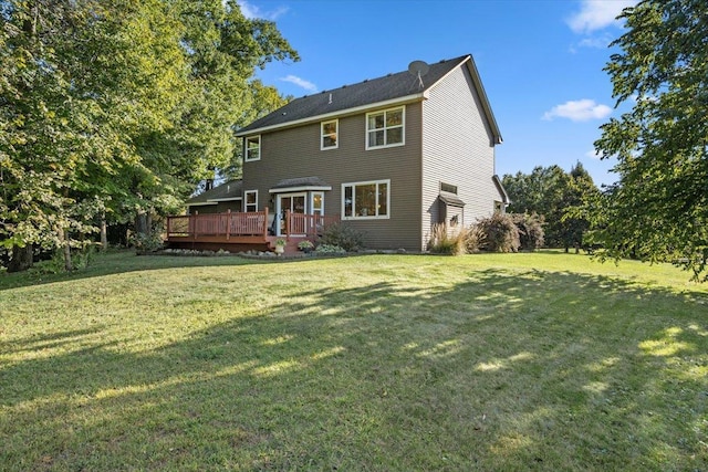 back of house with a lawn and a deck