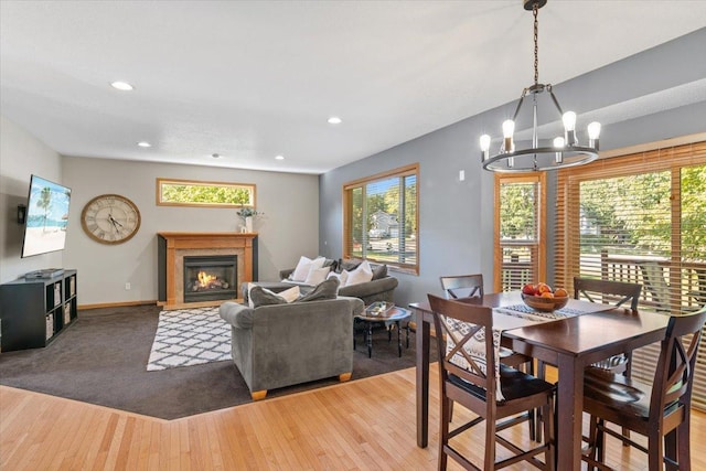 dining area featuring hardwood / wood-style flooring, plenty of natural light, and a notable chandelier