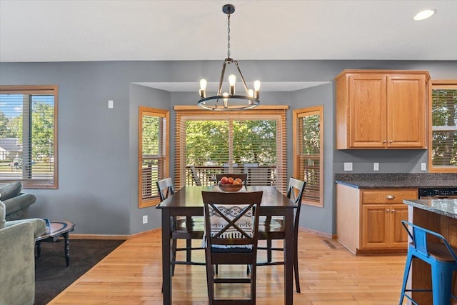 dining area featuring an inviting chandelier and light hardwood / wood-style floors