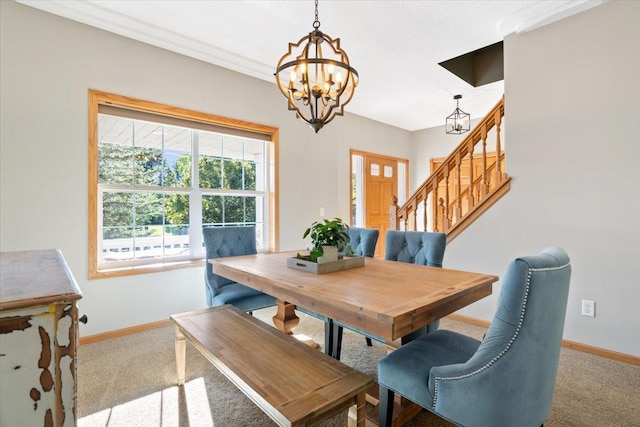 carpeted dining room with a notable chandelier