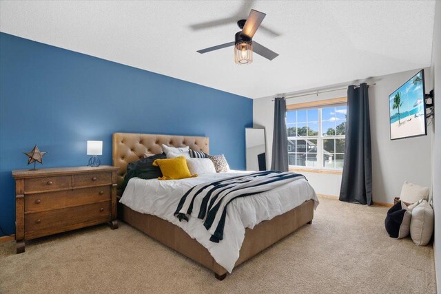 bedroom with ceiling fan and light carpet