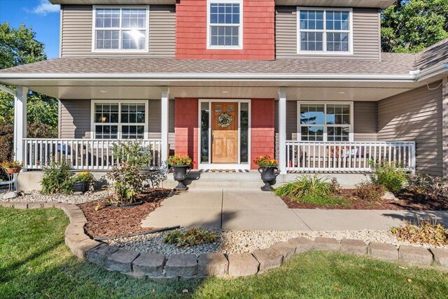 view of exterior entry with covered porch