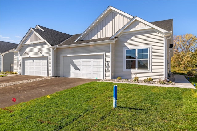 view of front of house with a front yard and a garage