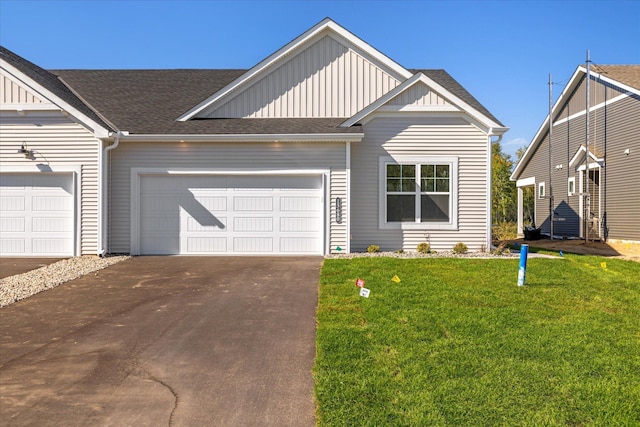 view of front of property with a garage and a front lawn