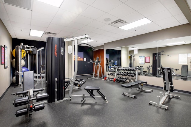 gym with a paneled ceiling