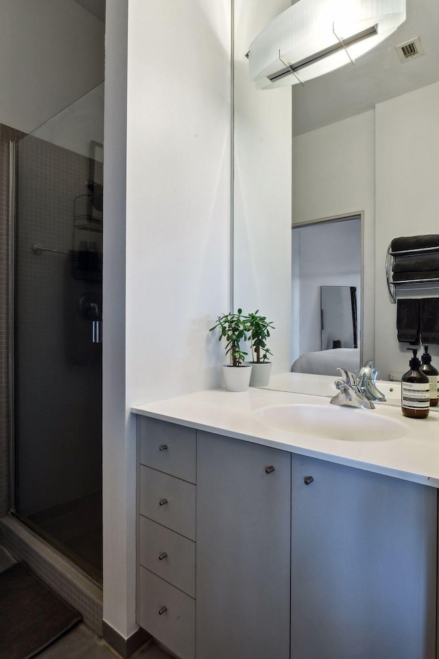 bathroom with vanity and a shower with door