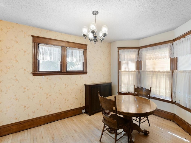 dining room featuring a wealth of natural light, a chandelier, and a textured ceiling