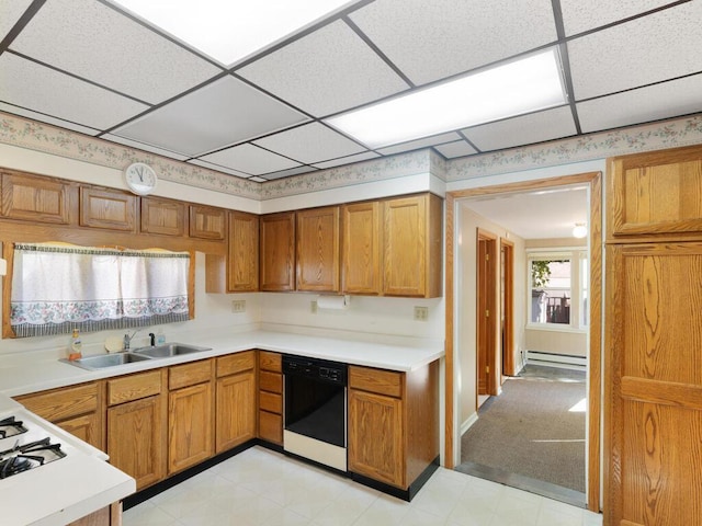 kitchen featuring baseboard heating, a paneled ceiling, sink, and black dishwasher