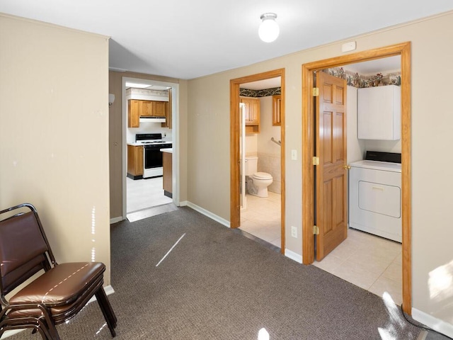 hall featuring light carpet and washer / clothes dryer