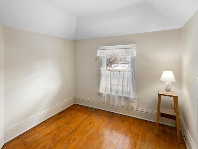 spare room with wood-type flooring