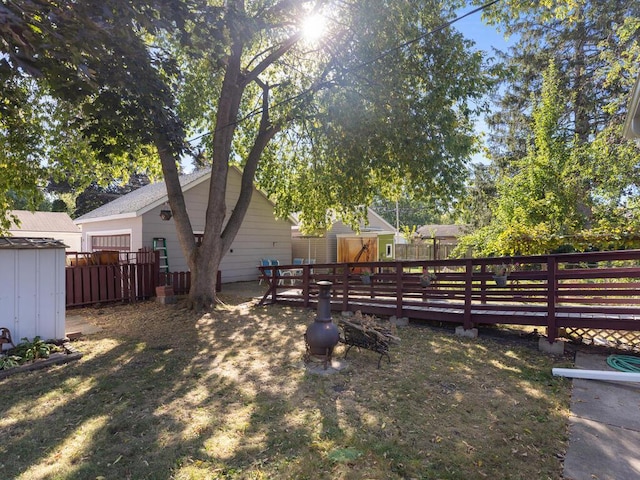 view of yard with a storage unit and a deck