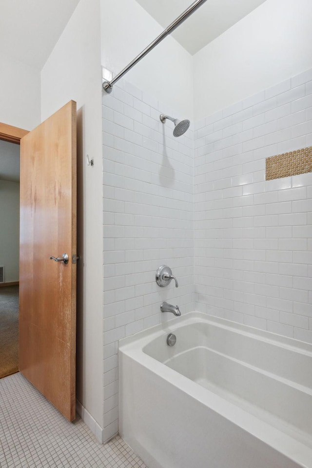 bathroom featuring tiled shower / bath combo and tile patterned floors