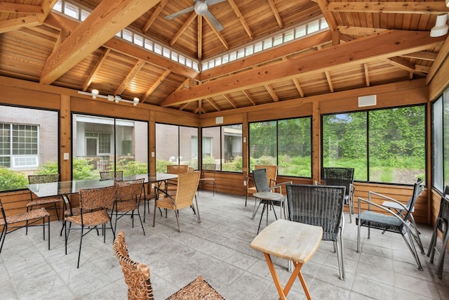 sunroom featuring lofted ceiling with beams, a wealth of natural light, and ceiling fan