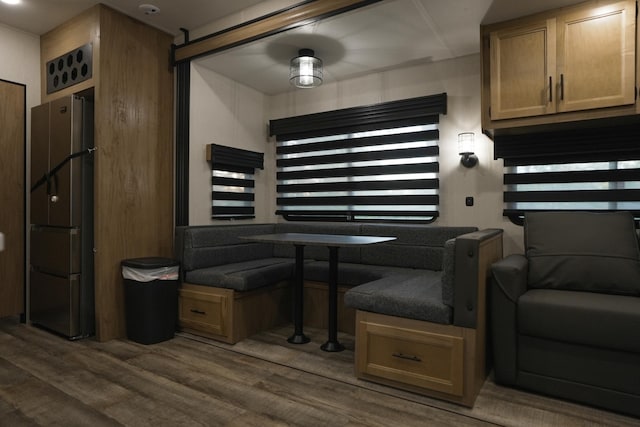 kitchen with stainless steel fridge, dark wood-type flooring, and plenty of natural light