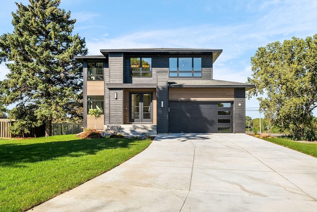 view of front of home with a garage and a front lawn