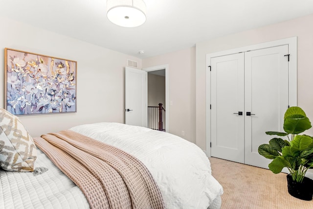 bedroom featuring light carpet and a closet