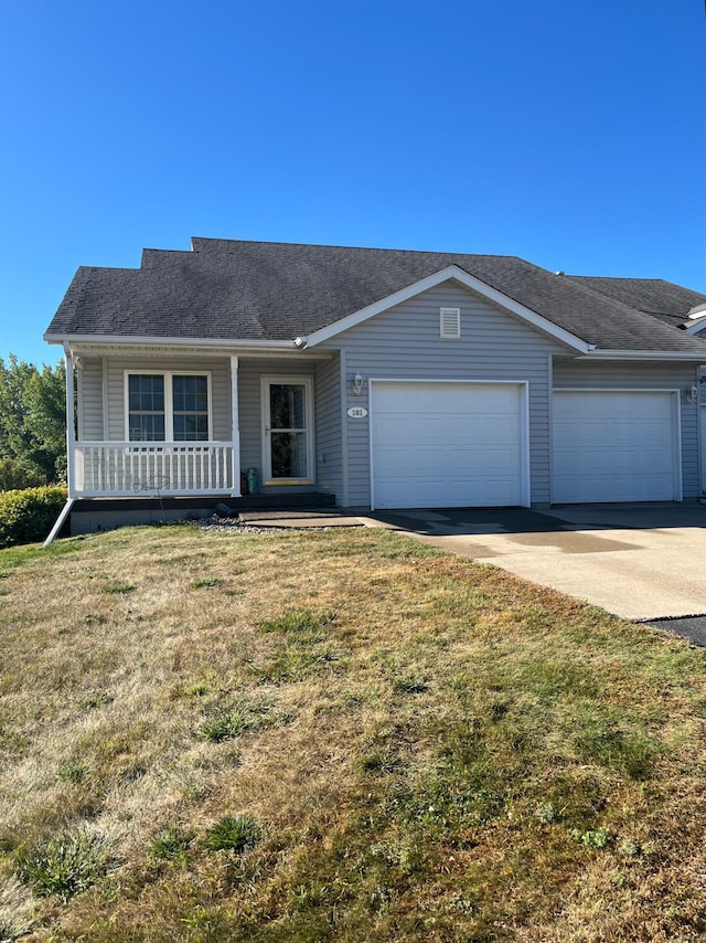 single story home featuring a garage, a front lawn, and a porch