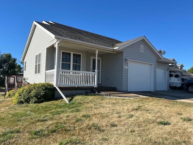 single story home featuring a garage, a front lawn, and covered porch